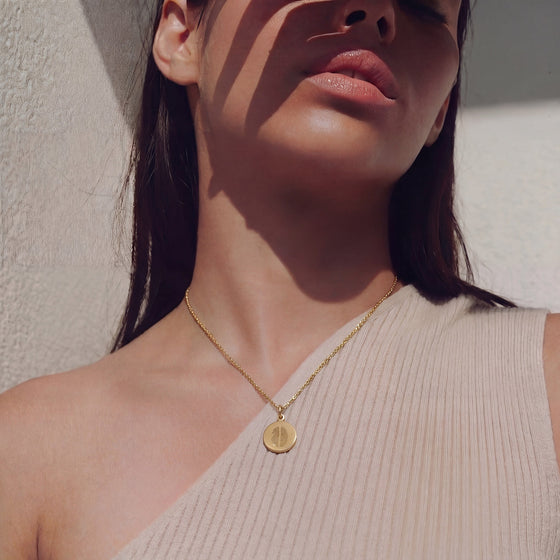 Goldene Kette mit zwei Fingerabdrücken, getragen