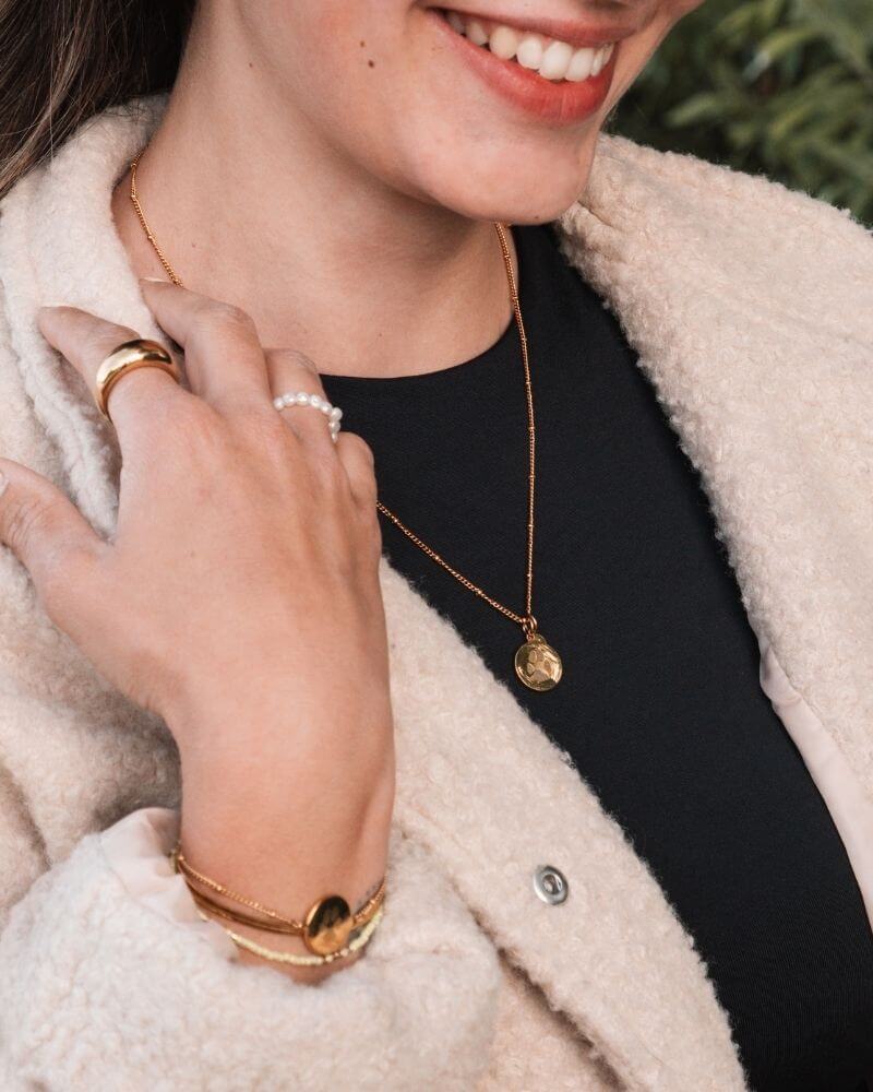 Proud pet mom showing off her Mizodia paw print jewelry.